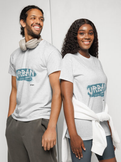 Two young adults stand back to back, smiling in casual athletic wear; man with beige headphones around his neck and a light grey T-shirt, woman in a grey top with a white jacket tied around her waist.