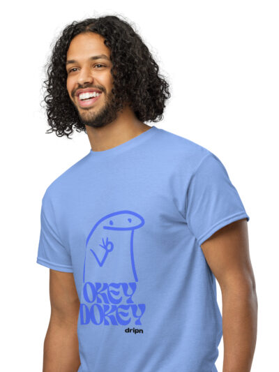 Smiling man with curly hair wearing a light blue graphic T-shirt, portrait shot against a white background.