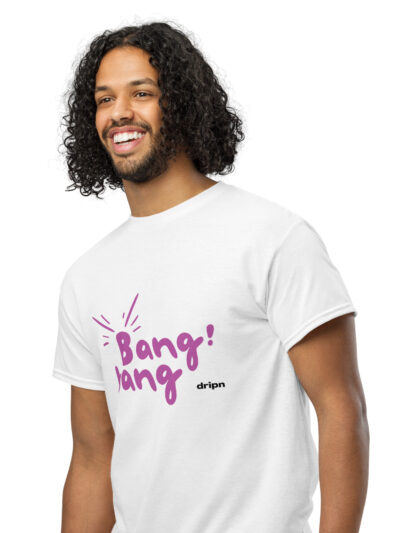 Smiling man with long, curly hair wearing a white T-shirt with a purple graphic text on the front.